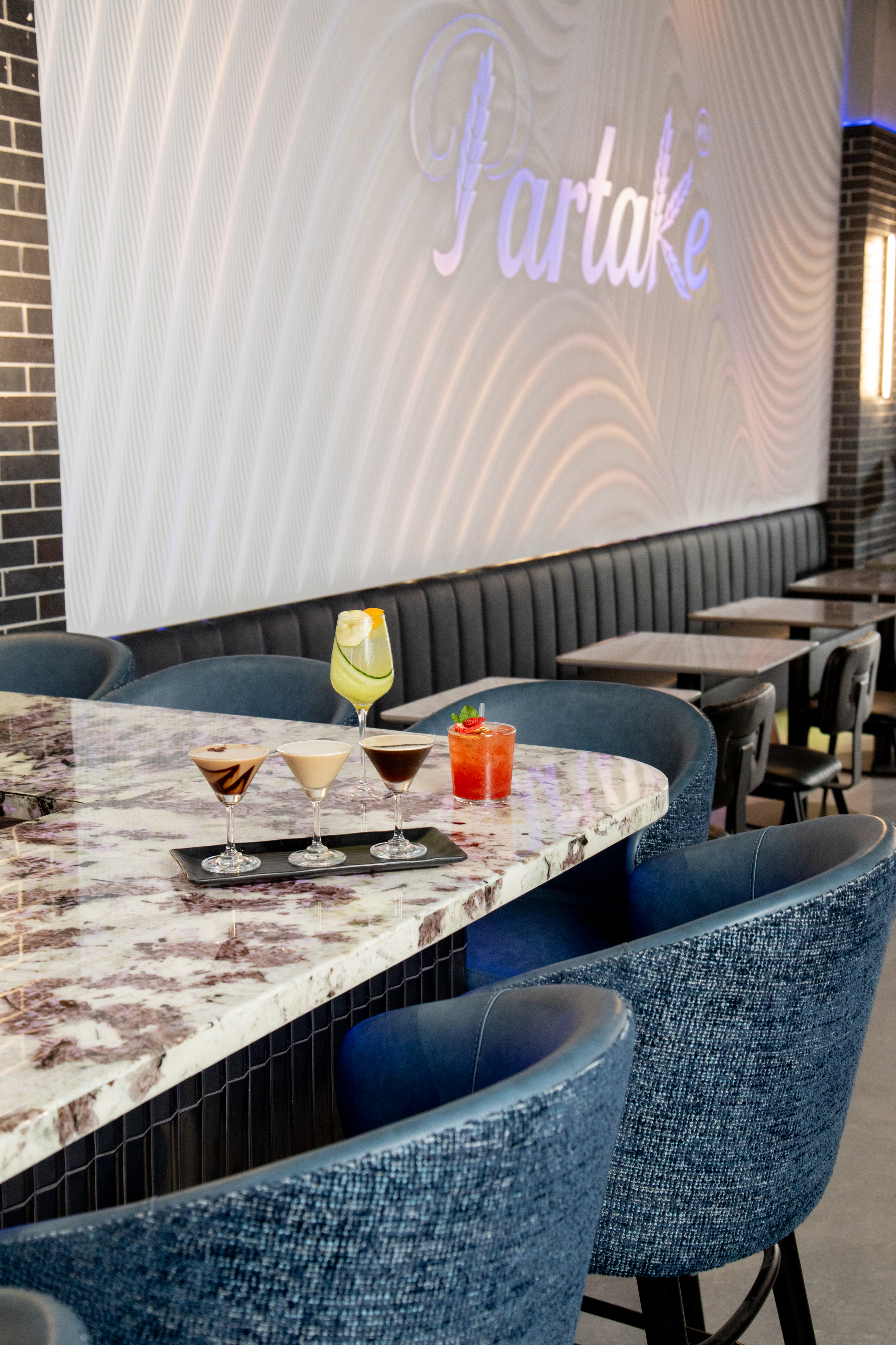 A martini flight on the marble bar at Partake NYC