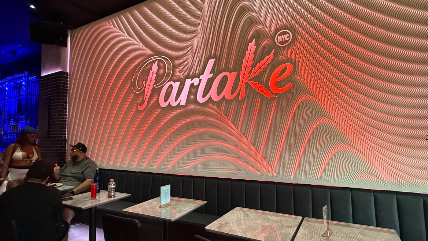 Tables along the illuminated Partake wall