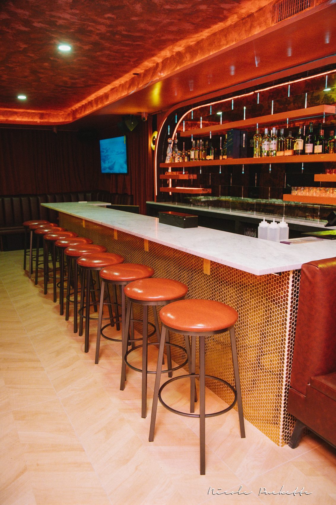 The Red Room bar at Partake NYC in copper, marble and red light